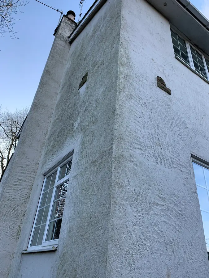 A full house elevation in a smooth pale render, finished and clean